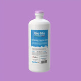 Detergent CENERE ATTIVA 1kg, etichetă albastră, sticlă albă, capac mov, fundal mov.